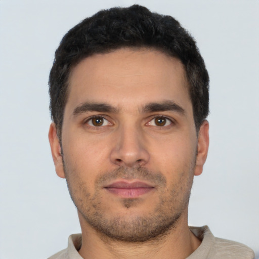 Neutral latino young-adult male with short  black hair and brown eyes