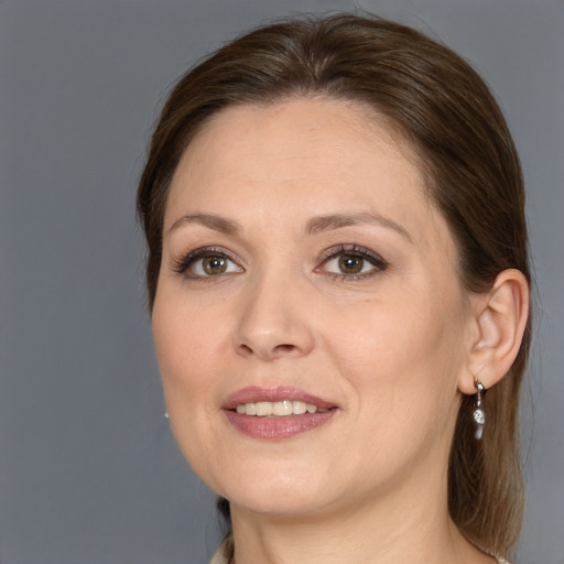 Joyful white adult female with medium  brown hair and grey eyes