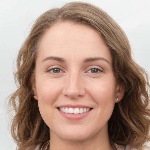 Joyful white young-adult female with long  brown hair and grey eyes