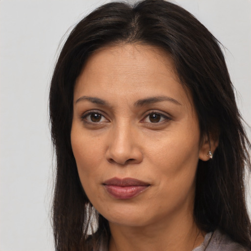 Joyful asian adult female with long  brown hair and brown eyes