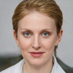 Joyful white young-adult female with medium  brown hair and blue eyes