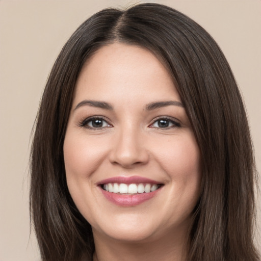 Joyful white young-adult female with long  brown hair and brown eyes