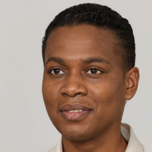 Joyful black young-adult male with short  black hair and brown eyes