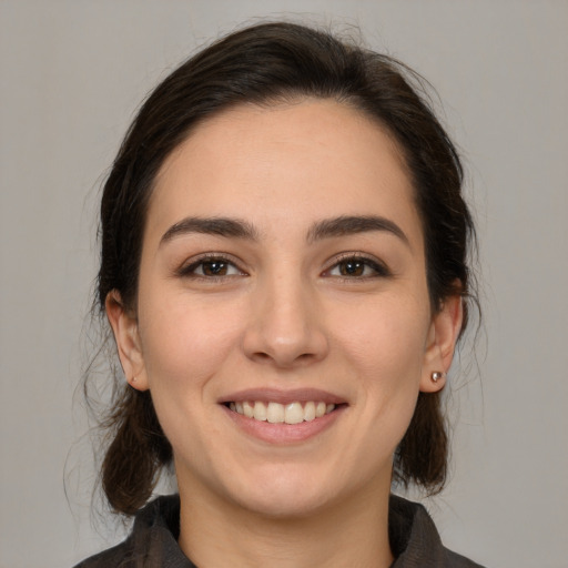 Joyful white young-adult female with medium  brown hair and brown eyes