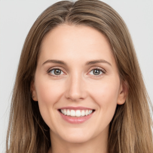 Joyful white young-adult female with long  brown hair and grey eyes