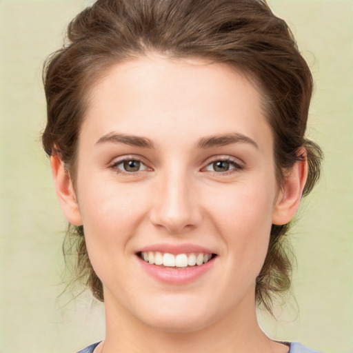 Joyful white young-adult female with medium  brown hair and green eyes