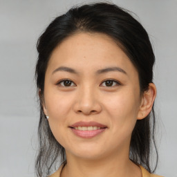 Joyful asian young-adult female with medium  brown hair and brown eyes