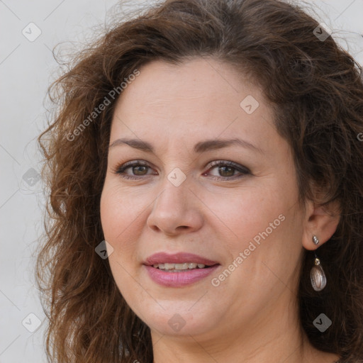 Joyful white adult female with long  brown hair and brown eyes