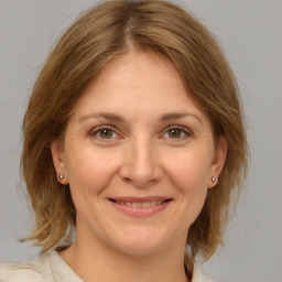 Joyful white adult female with medium  brown hair and grey eyes