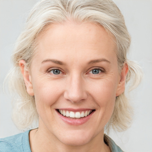 Joyful white young-adult female with medium  blond hair and blue eyes