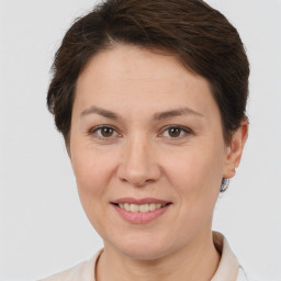 Joyful white adult female with short  brown hair and brown eyes