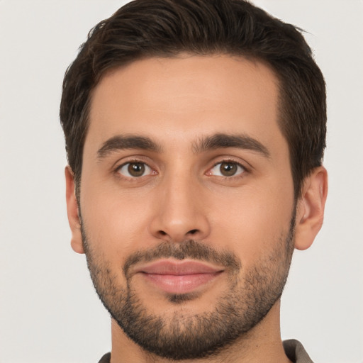 Joyful white young-adult male with short  brown hair and brown eyes