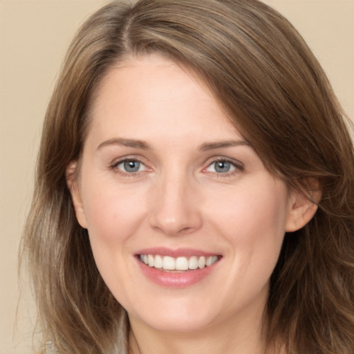 Joyful white young-adult female with long  brown hair and grey eyes