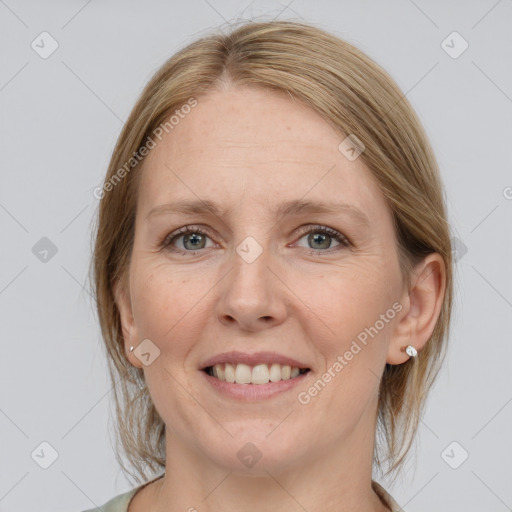 Joyful white adult female with medium  brown hair and blue eyes