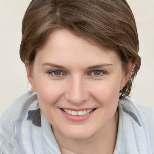 Joyful white young-adult female with medium  brown hair and grey eyes