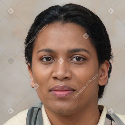 Joyful black adult female with medium  brown hair and brown eyes