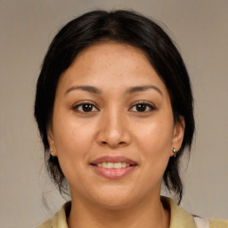 Joyful latino young-adult female with medium  brown hair and brown eyes