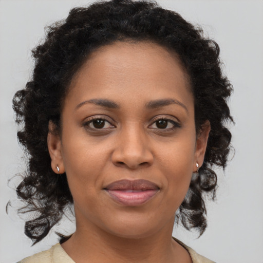 Joyful black young-adult female with medium  brown hair and brown eyes