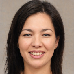 Joyful asian young-adult female with long  brown hair and brown eyes