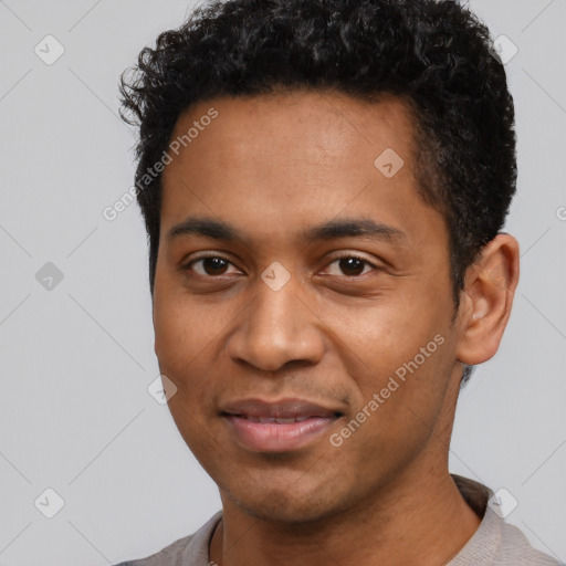 Joyful black young-adult male with short  black hair and brown eyes