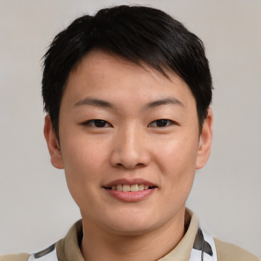 Joyful asian young-adult female with short  brown hair and brown eyes