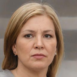 Joyful white adult female with medium  brown hair and brown eyes