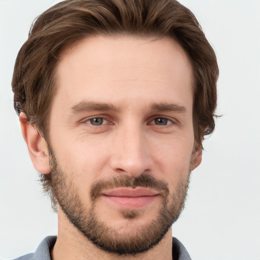 Joyful white young-adult male with short  brown hair and grey eyes