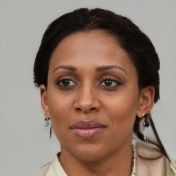 Joyful black adult female with short  brown hair and brown eyes