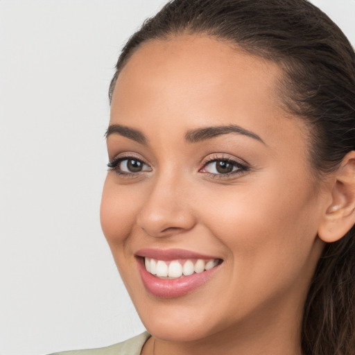 Joyful white young-adult female with long  brown hair and brown eyes