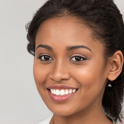 Joyful latino young-adult female with long  brown hair and brown eyes