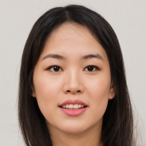 Joyful asian young-adult female with long  brown hair and brown eyes