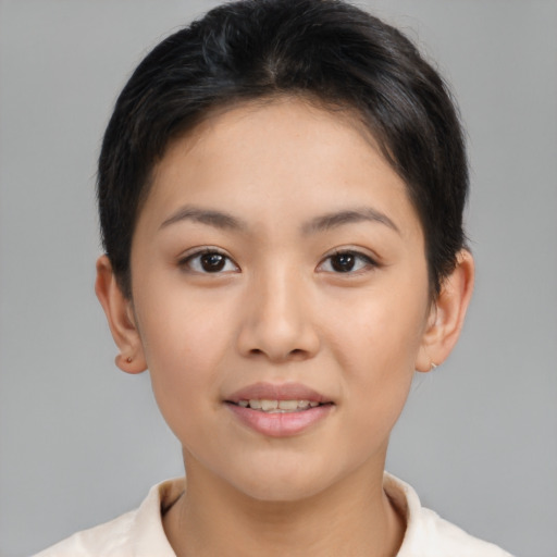 Joyful asian young-adult female with short  brown hair and brown eyes