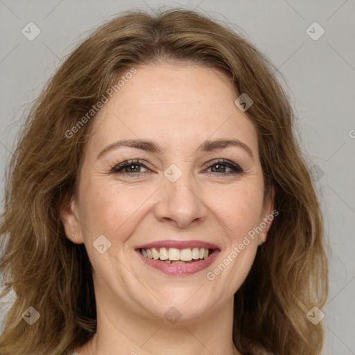 Joyful white adult female with long  brown hair and brown eyes