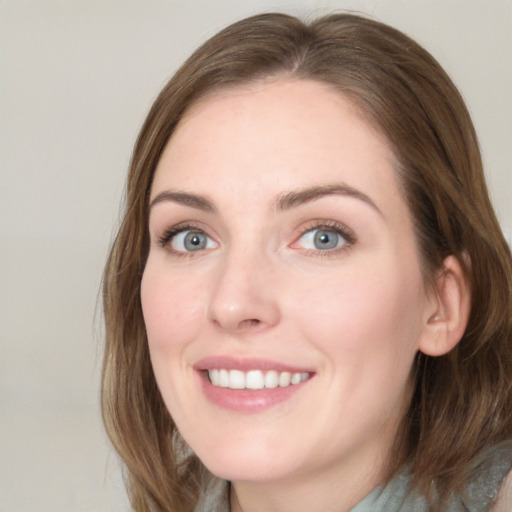 Joyful white young-adult female with long  brown hair and blue eyes