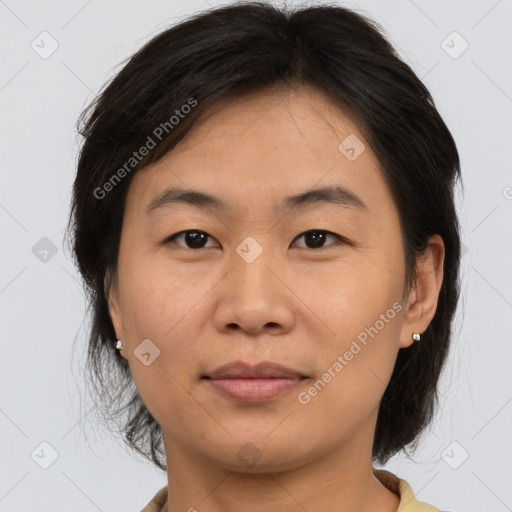 Joyful asian adult female with medium  brown hair and brown eyes