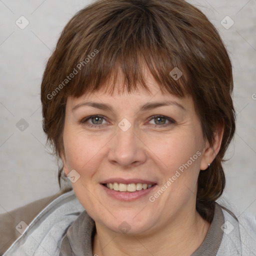 Joyful white adult female with medium  brown hair and grey eyes