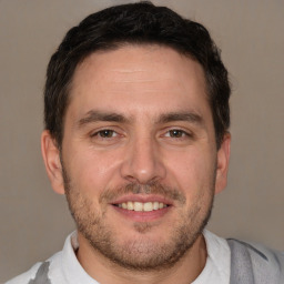 Joyful white adult male with short  brown hair and brown eyes