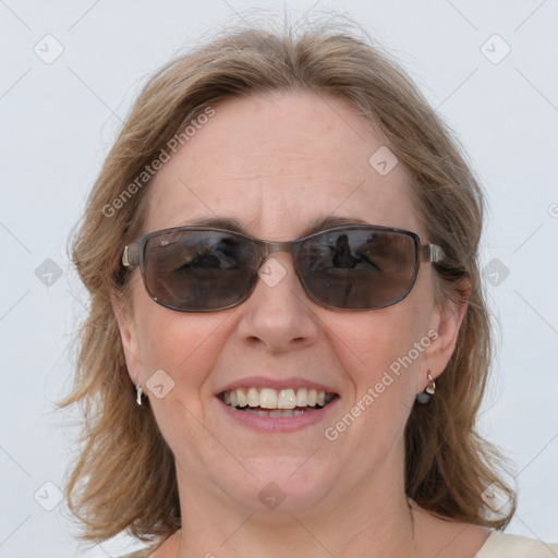 Joyful white adult female with medium  brown hair and blue eyes