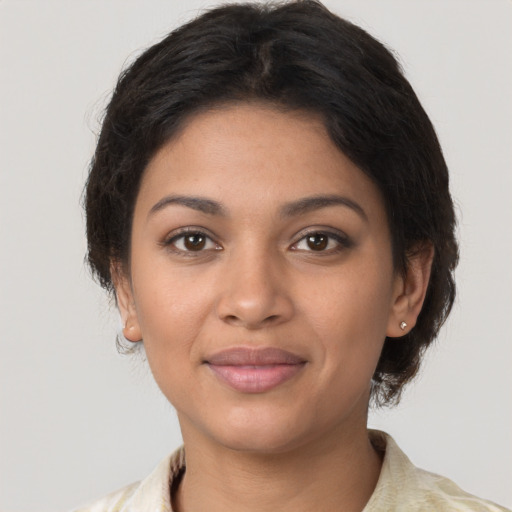 Joyful latino young-adult female with short  brown hair and brown eyes