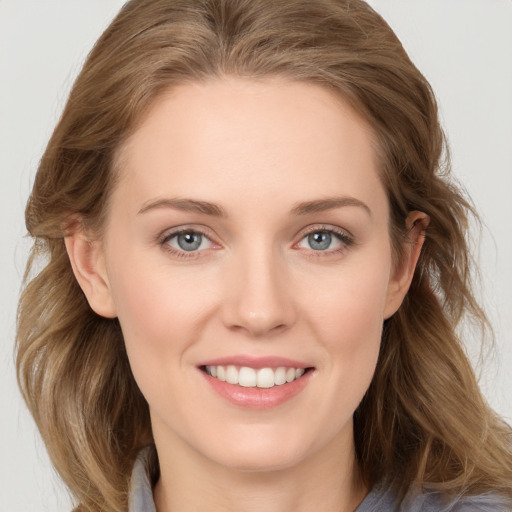 Joyful white young-adult female with medium  brown hair and blue eyes