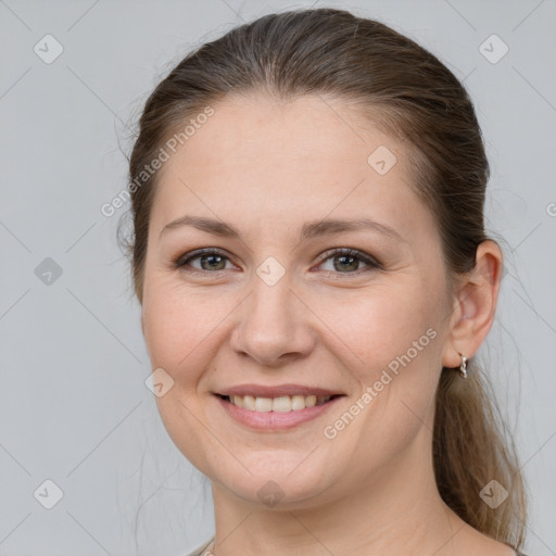 Joyful white young-adult female with medium  brown hair and grey eyes