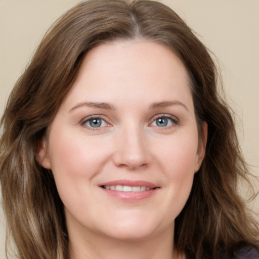 Joyful white young-adult female with long  brown hair and grey eyes