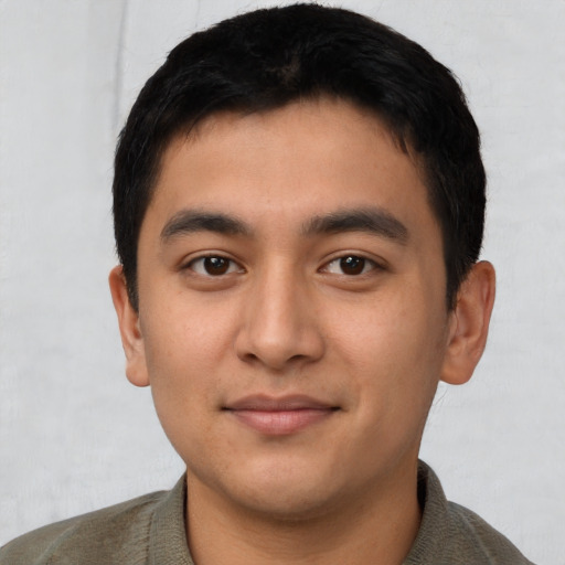 Joyful latino young-adult male with short  black hair and brown eyes