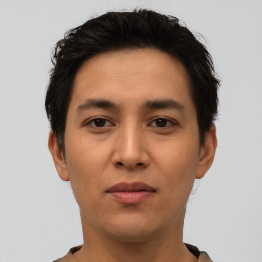 Joyful latino young-adult male with short  brown hair and brown eyes