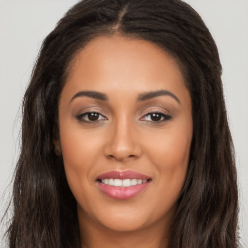 Joyful latino young-adult female with long  brown hair and brown eyes