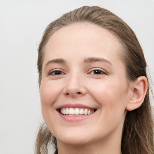 Joyful white young-adult female with long  brown hair and grey eyes