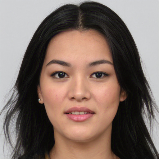 Joyful asian young-adult female with long  black hair and brown eyes