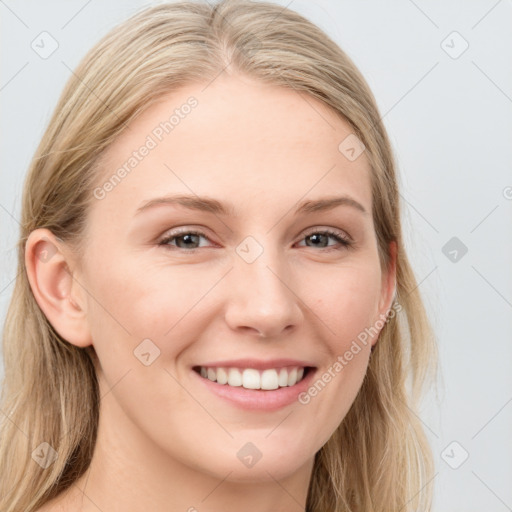 Joyful white young-adult female with long  brown hair and blue eyes