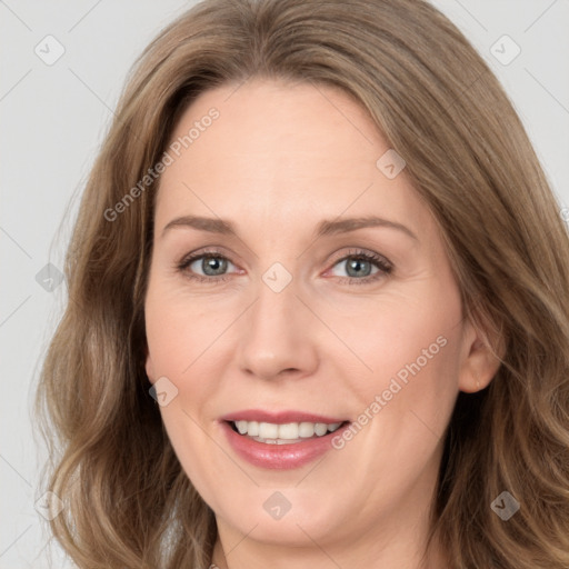 Joyful white adult female with medium  brown hair and green eyes