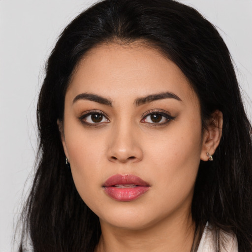 Neutral latino young-adult female with long  brown hair and brown eyes
